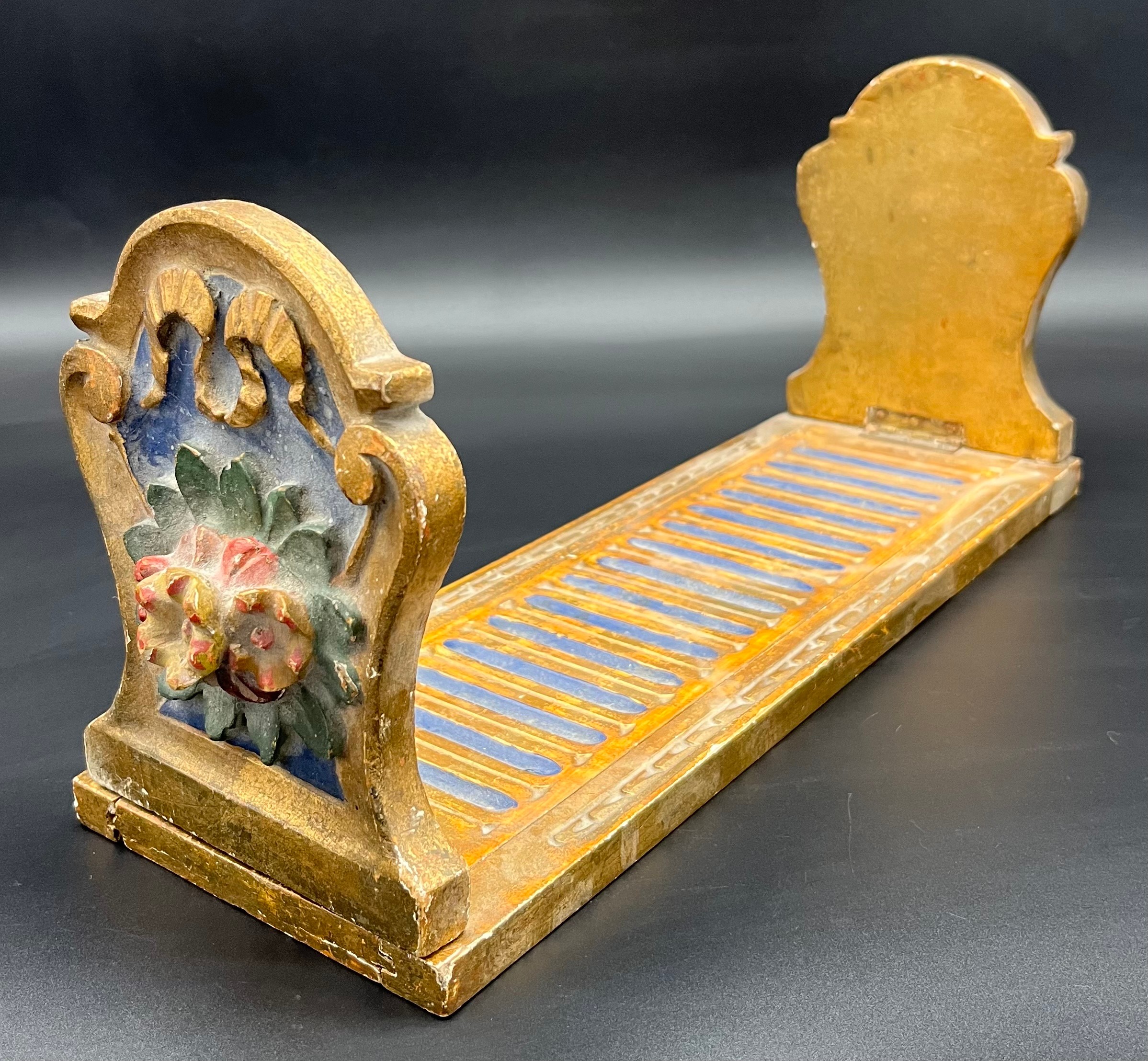 A Regency style moulded and gilt painted table top book shelf.