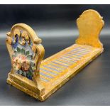 A Regency style moulded and gilt painted table top book shelf.