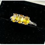 10ct white gold ladies ring set with three yellow tourmaline stones off set by a diamond to each