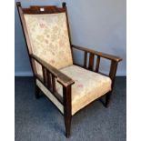 Arts & Crafts oak Gentleman's armchair, the long-cushioned back above a cushioned seat raised on