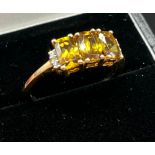 10ct yellow gold ladies ring set with three yellow tourmaline stones off set by diamond
