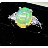 10ct white gold ladies ring set with an opalescent style stone, off set by purple tourmaline and