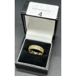 Birmingham marked 9ct yellow gold Celtic design band ring. [Ring size R] [3.90Grams]