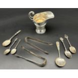 A Collection of silver items includes cream jug, Chinese caddy spoon, Georgian sugar tongs and