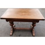 Antique oak extending dining table, the rectangular surface raised by carved acorn design columns