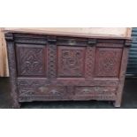17th century oak trunk, the lift-up top opening to interior storage, the peripheral highly carved,