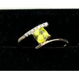 10ct yellow gold ladies ring set with a cushion cut green tourmaline off set by seven white topaz