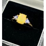 10ct yellow gold ladies ring set with an opalescent style stone off set by purple tourmaline stone