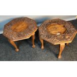 Two highly carved Indian style side tables, the octagonal top raised by shaped legs ending in claw