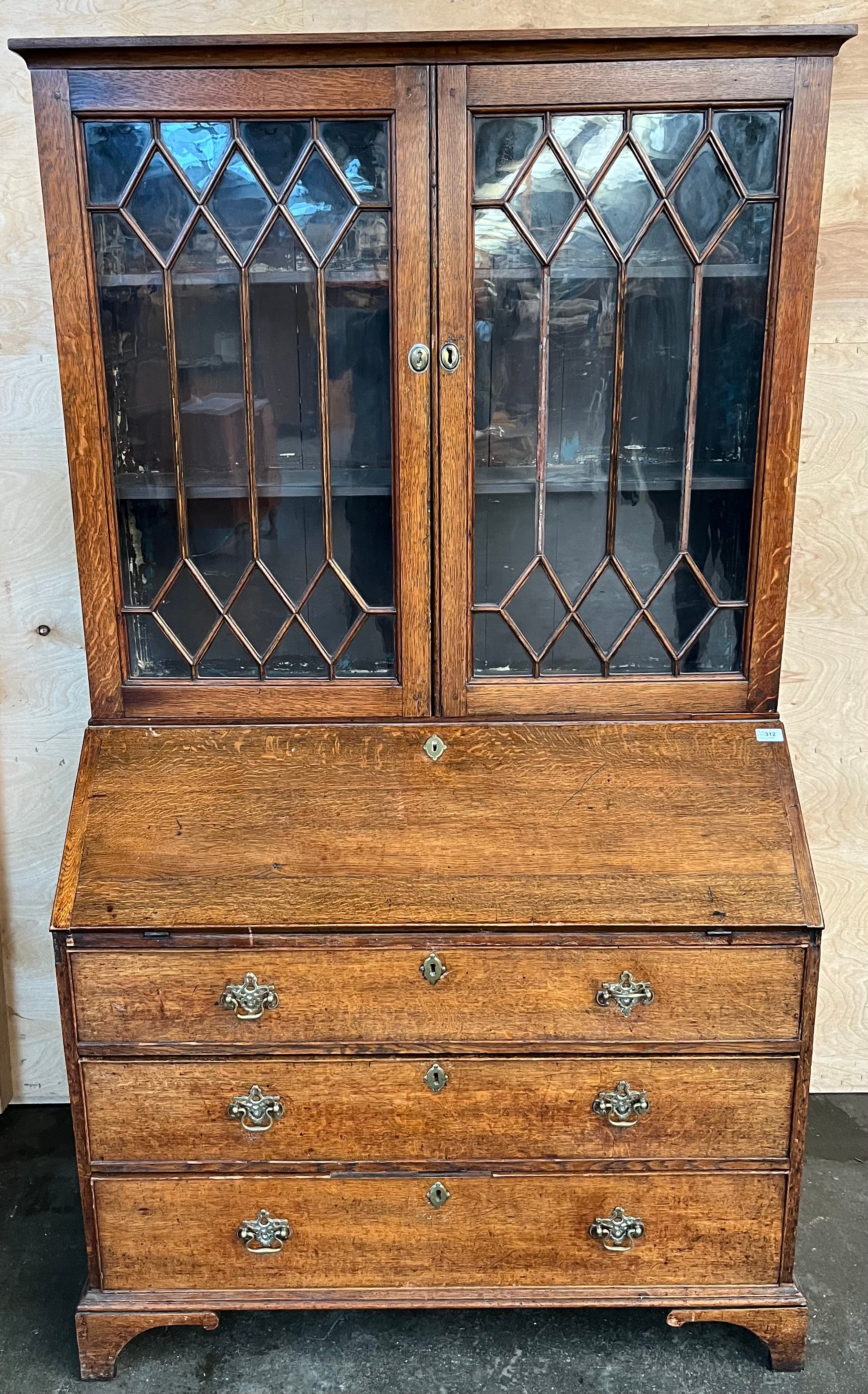 19th century bureau bookcase, the top with glass doors with a moulded wooden design to the panels,