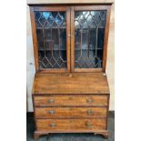 19th century bureau bookcase, the top with glass doors with a moulded wooden design to the panels,