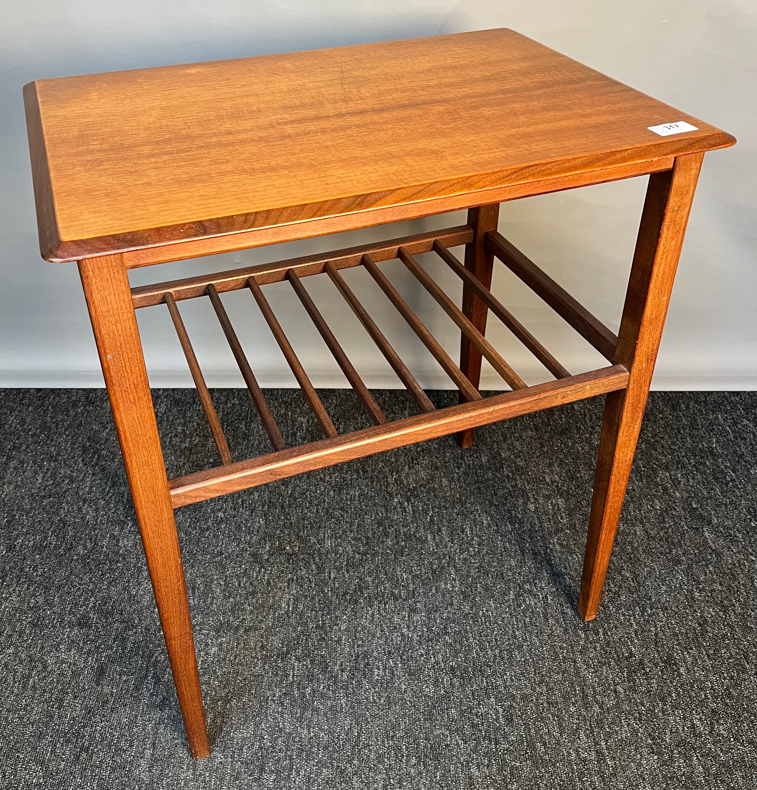 Mid-century side table, the rectangular top above a racked shelf, raised on square tapered legs [