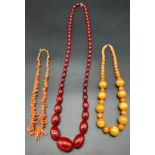 Three vintage necklaces to include coral necklace, glass ball effect necklace and cherry amber style