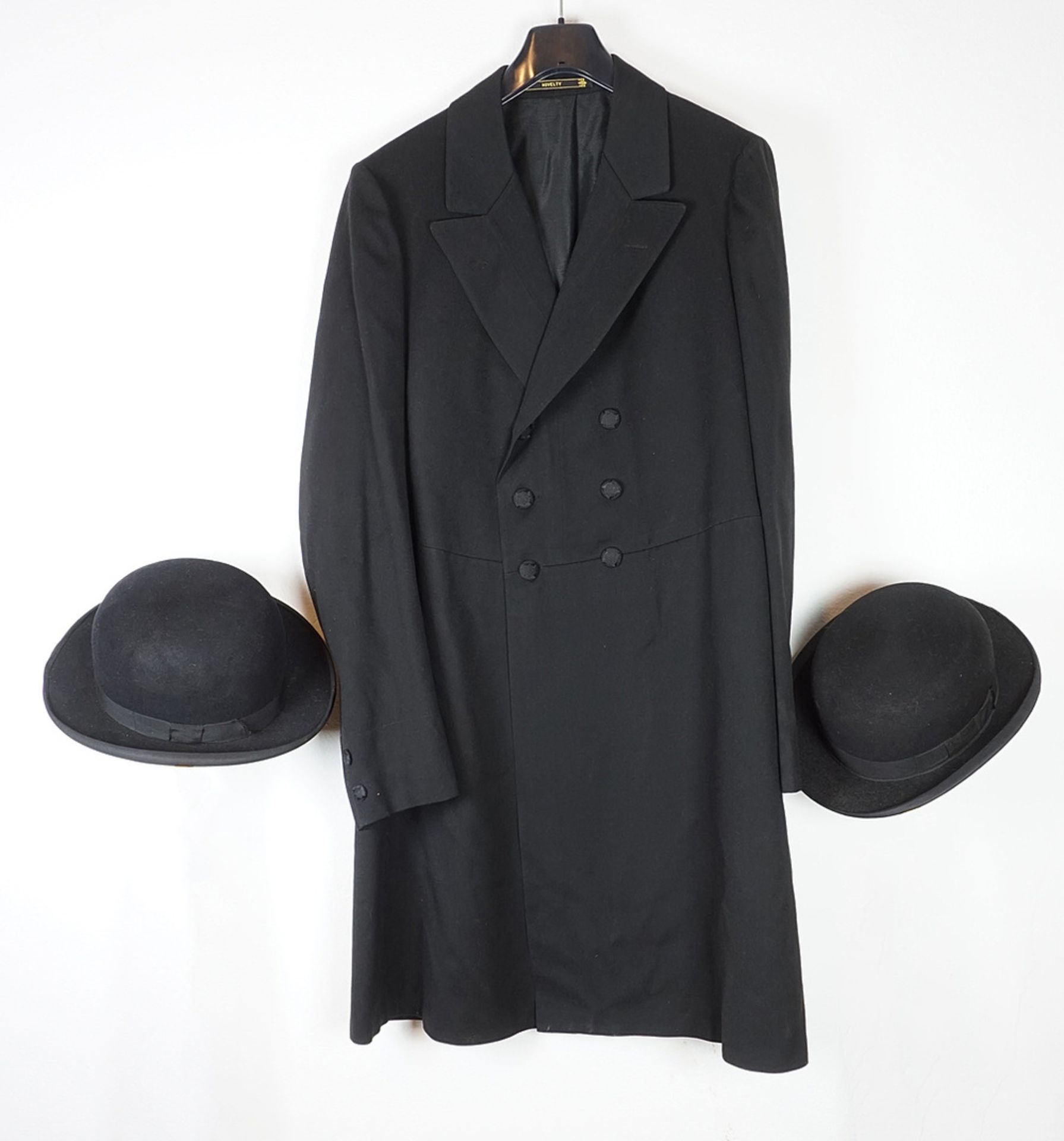 Frock-coat and two bowler hats