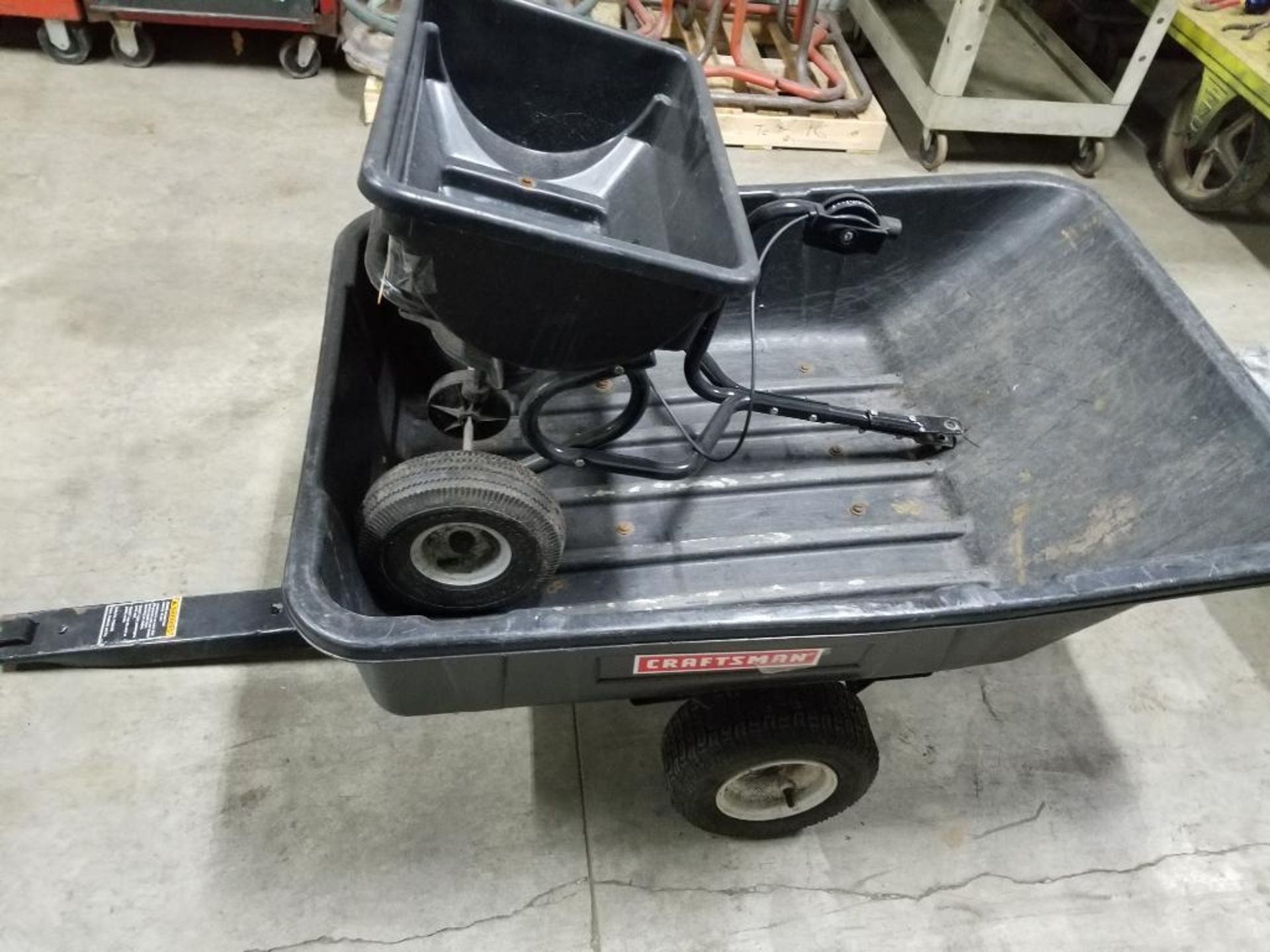 Qty 2 - Assorted lawn equipment. Spreader and wheel barrel.