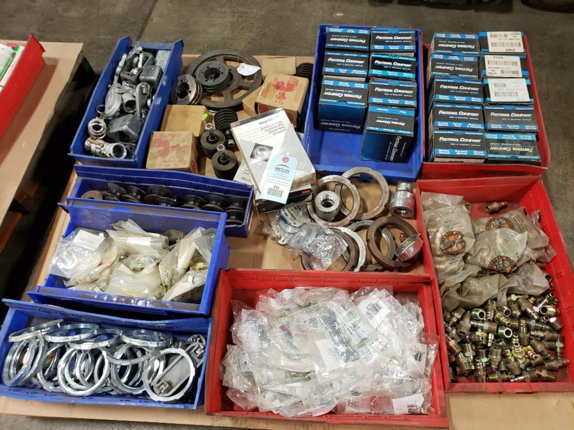 Pallet of assorted hardware. Rings, rollers, gears, fittings.