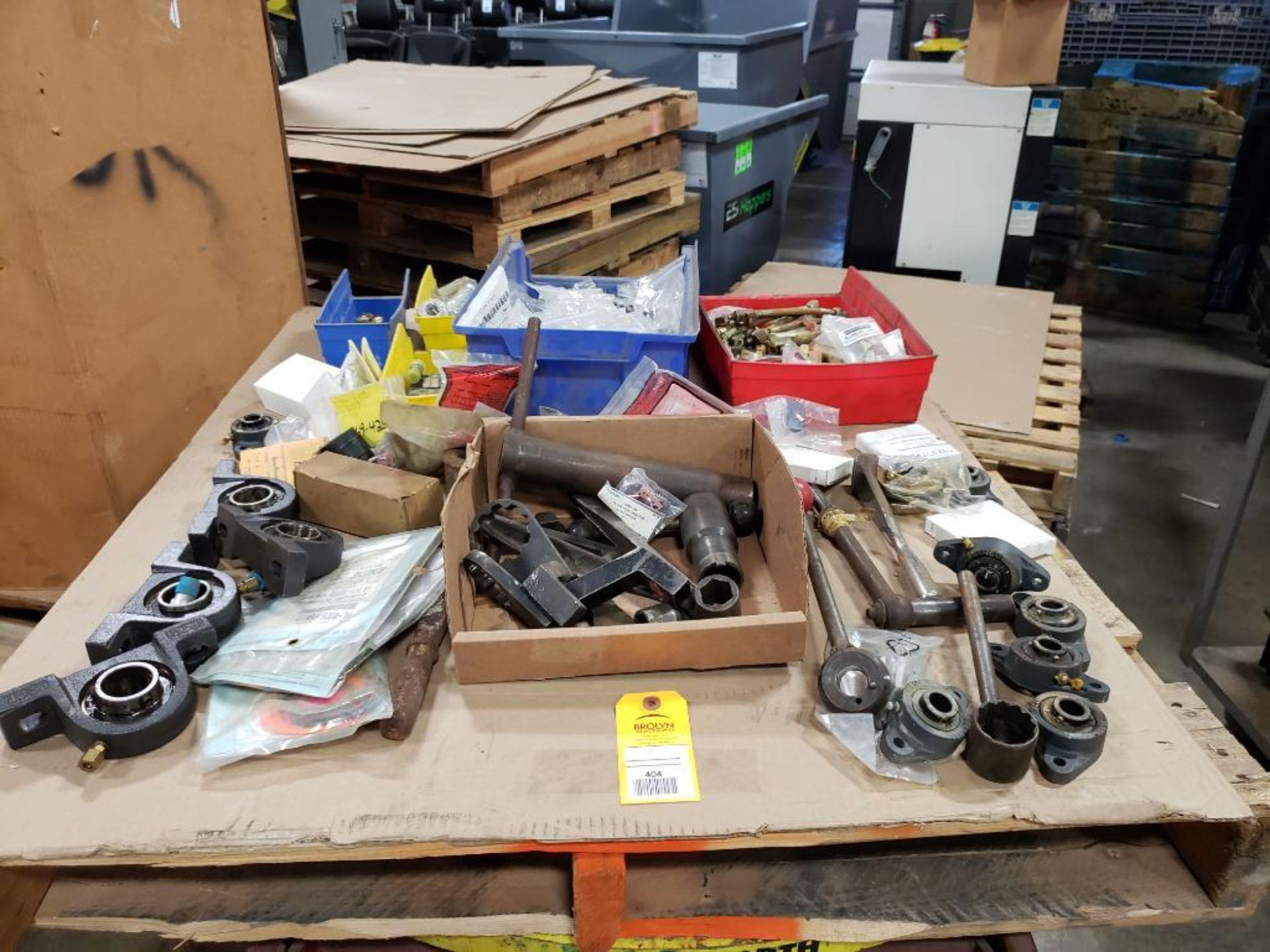 Pallet of assorted replacement parts. Bearings, wrenches hoses.