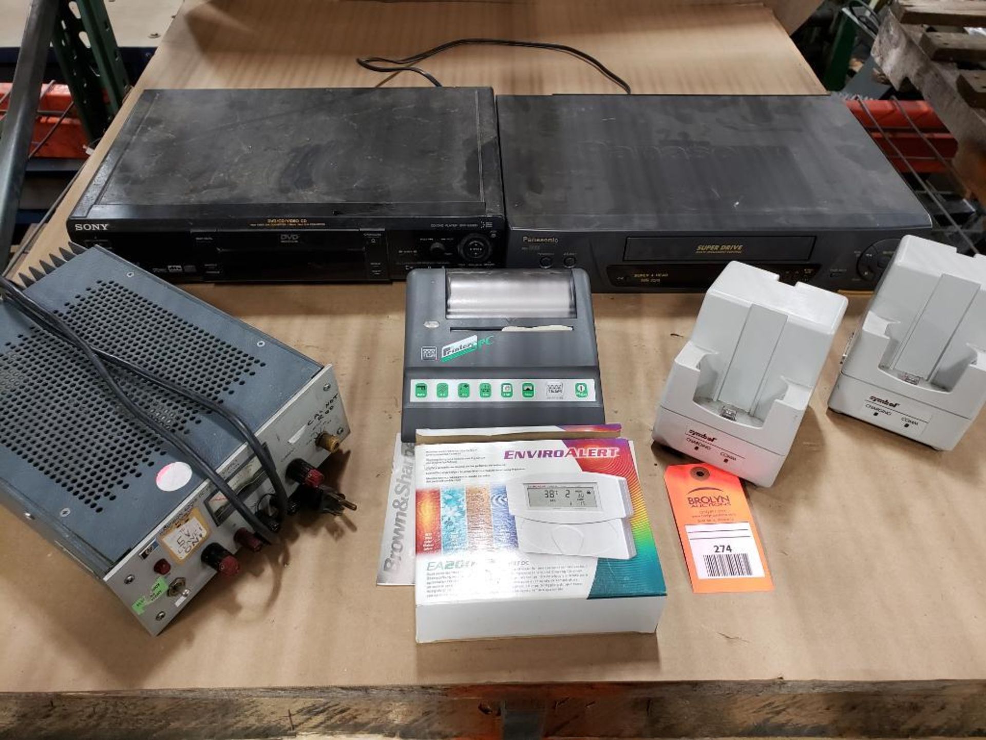 Assorted electrical power supply, charging stations, VCR, DVD players.