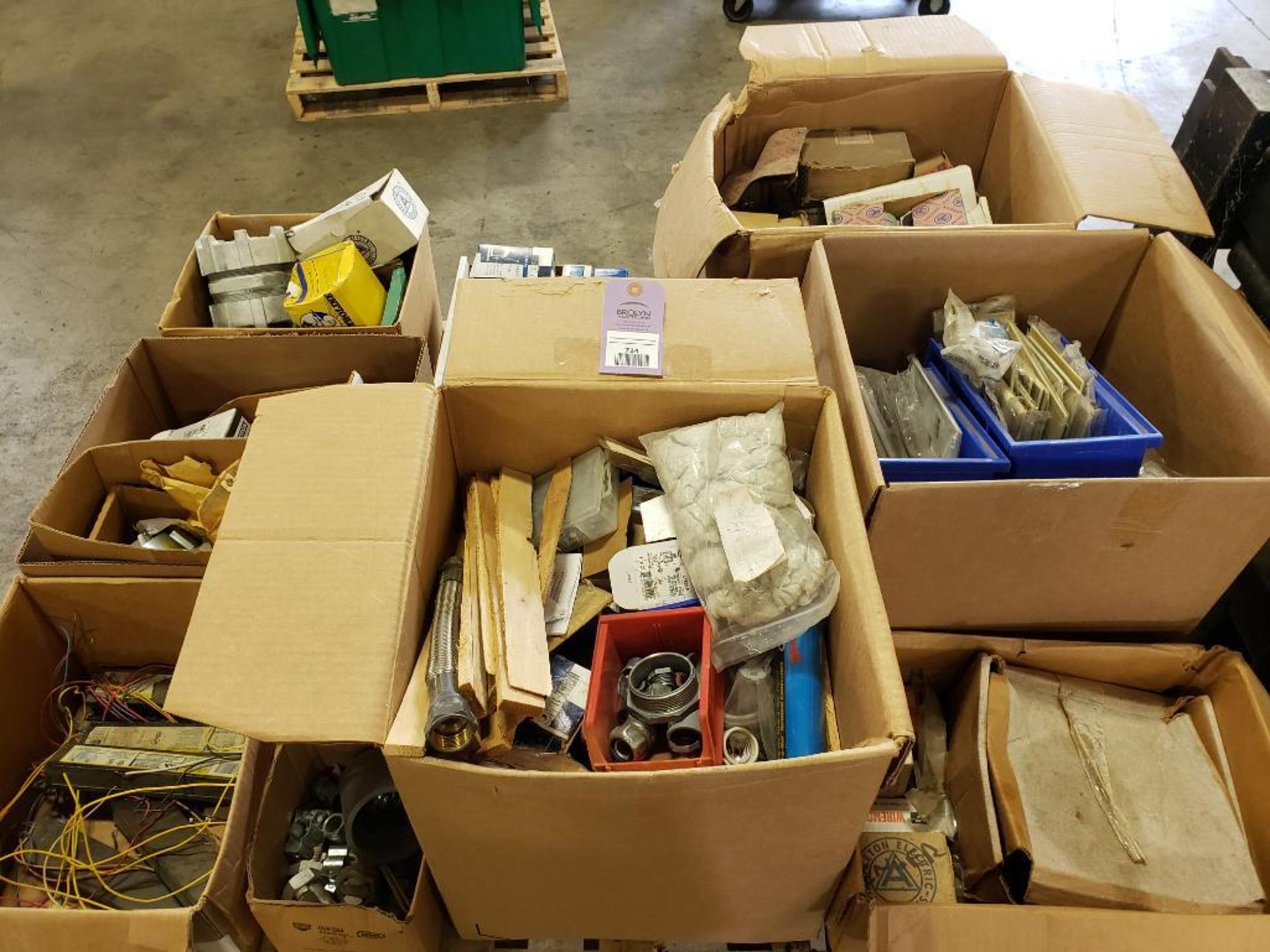 Pallet of assorted electrical hardware and construction equipment.