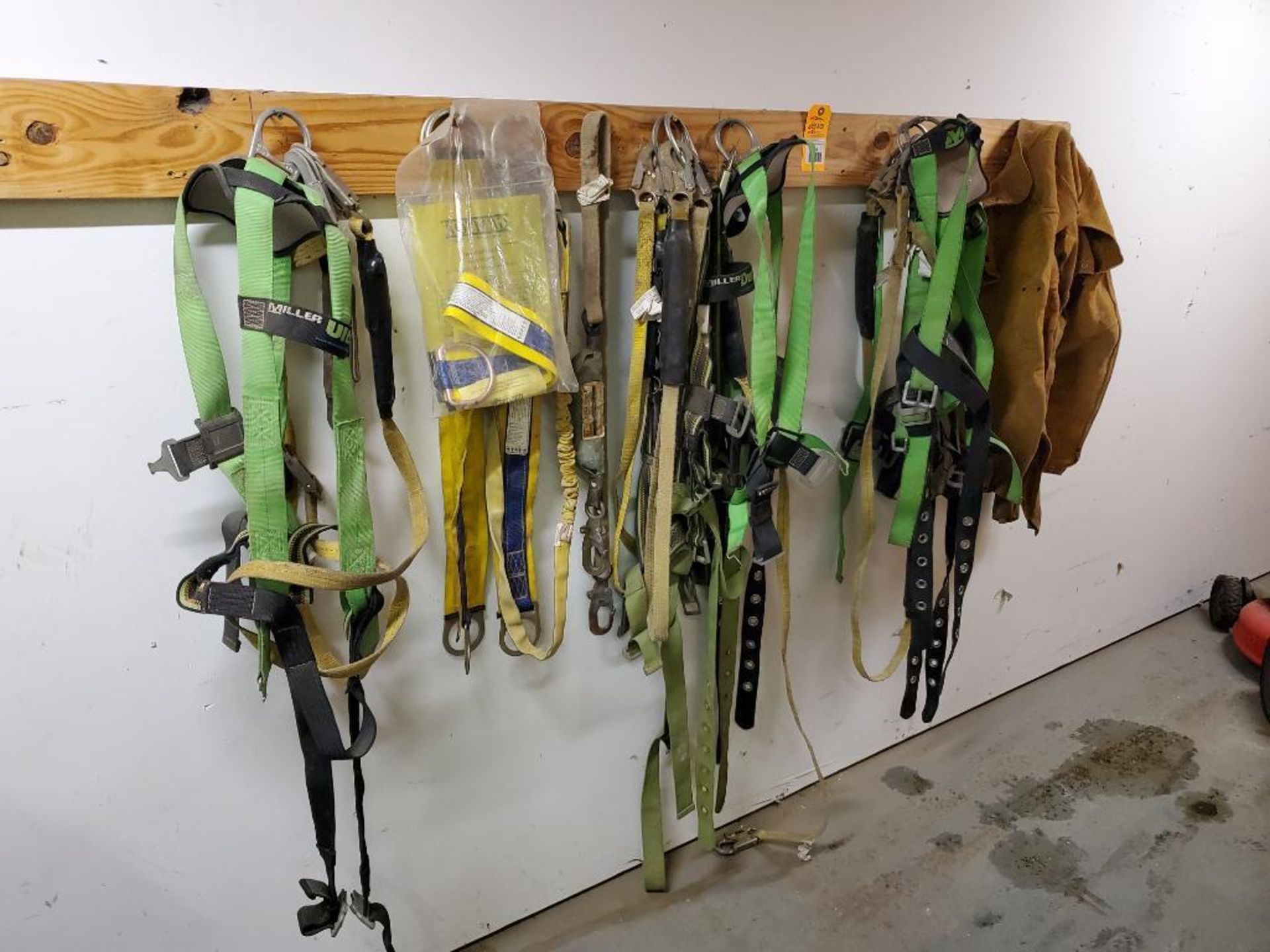 Large assortment of safety harnesses.