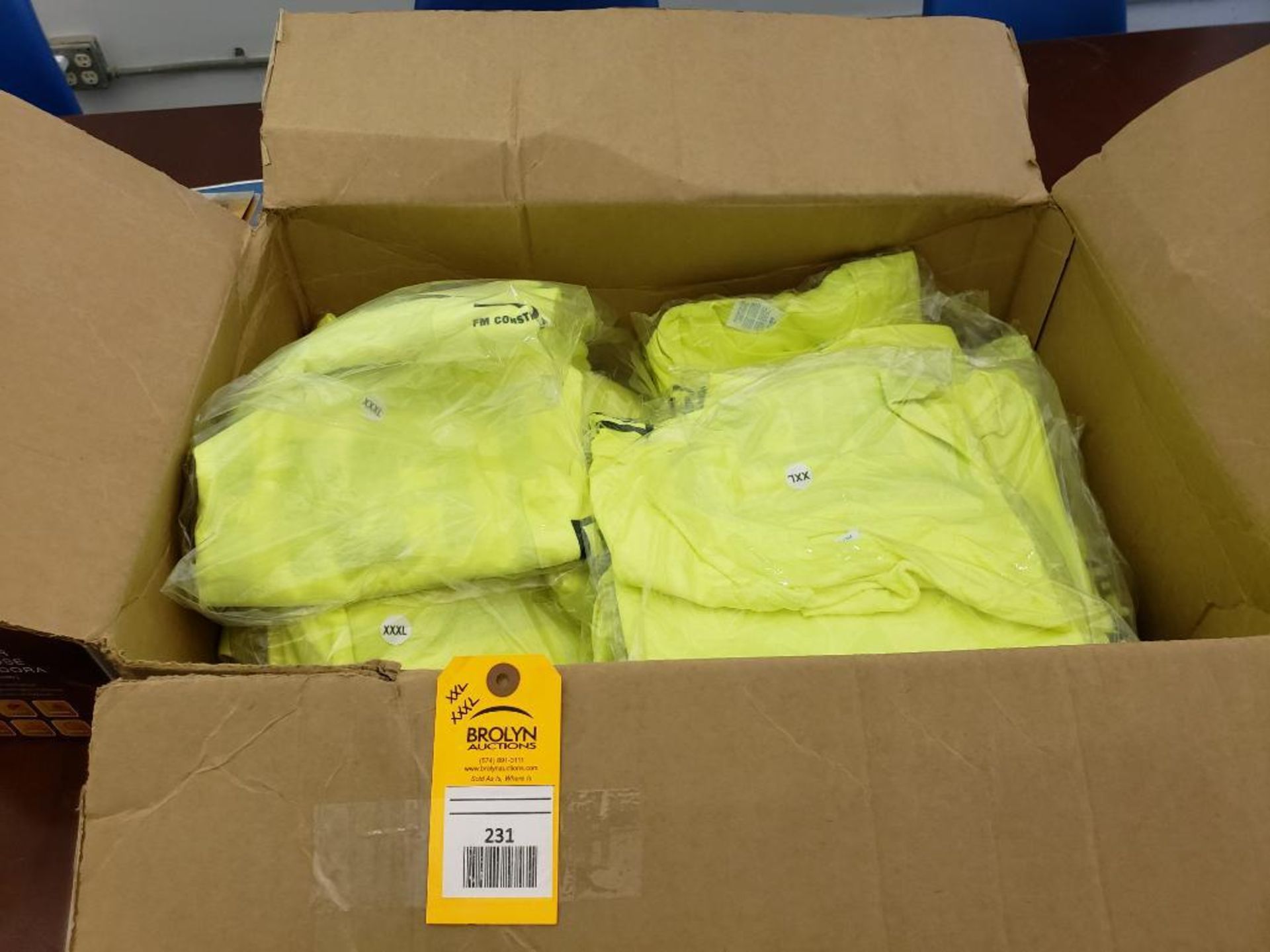 Large assortment of safety yellow FM Construction T-shirts.