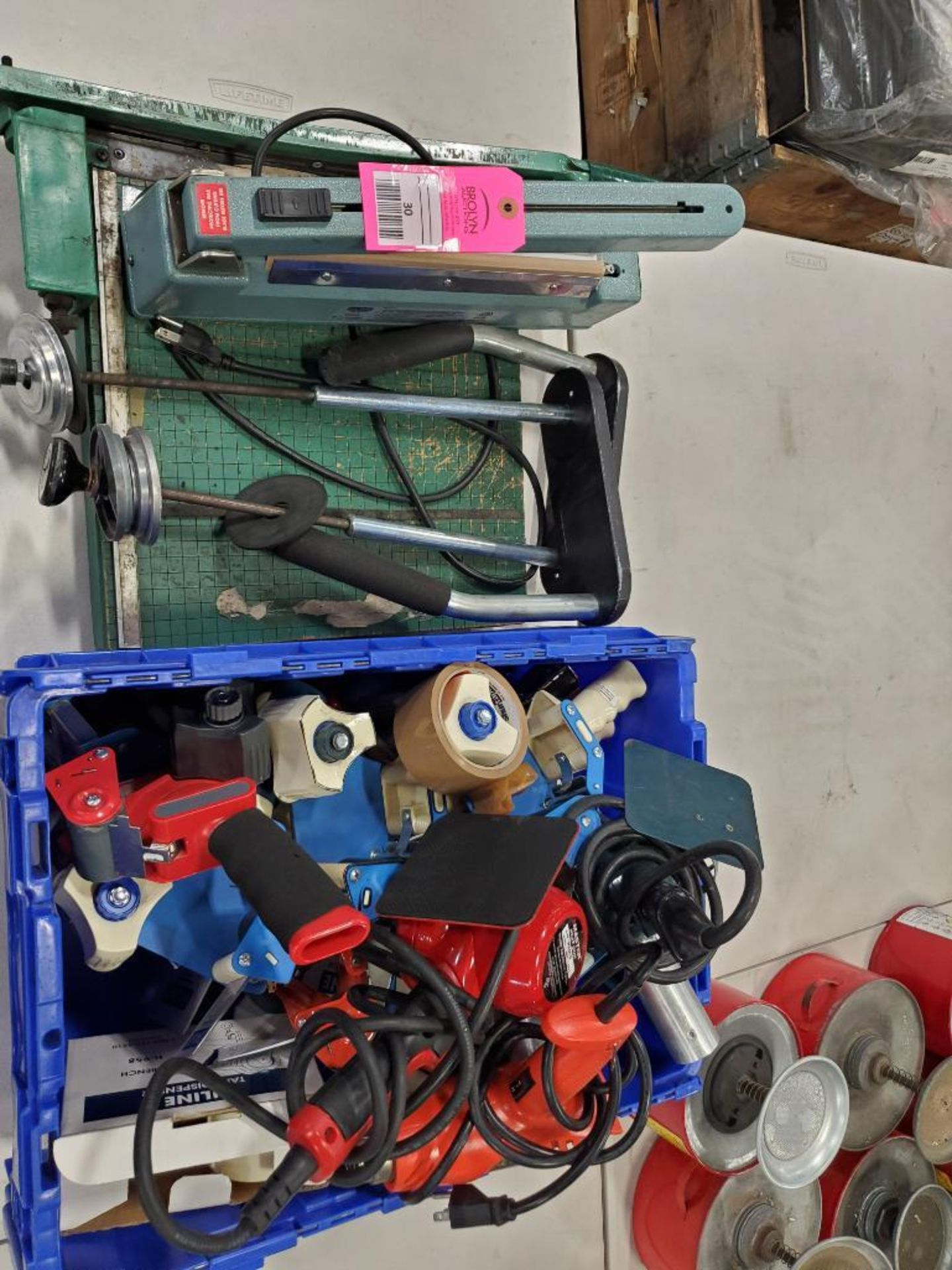 Assorted material handling equipment. Sealing machine, pallet wrap handles, tape guns, heat gun.