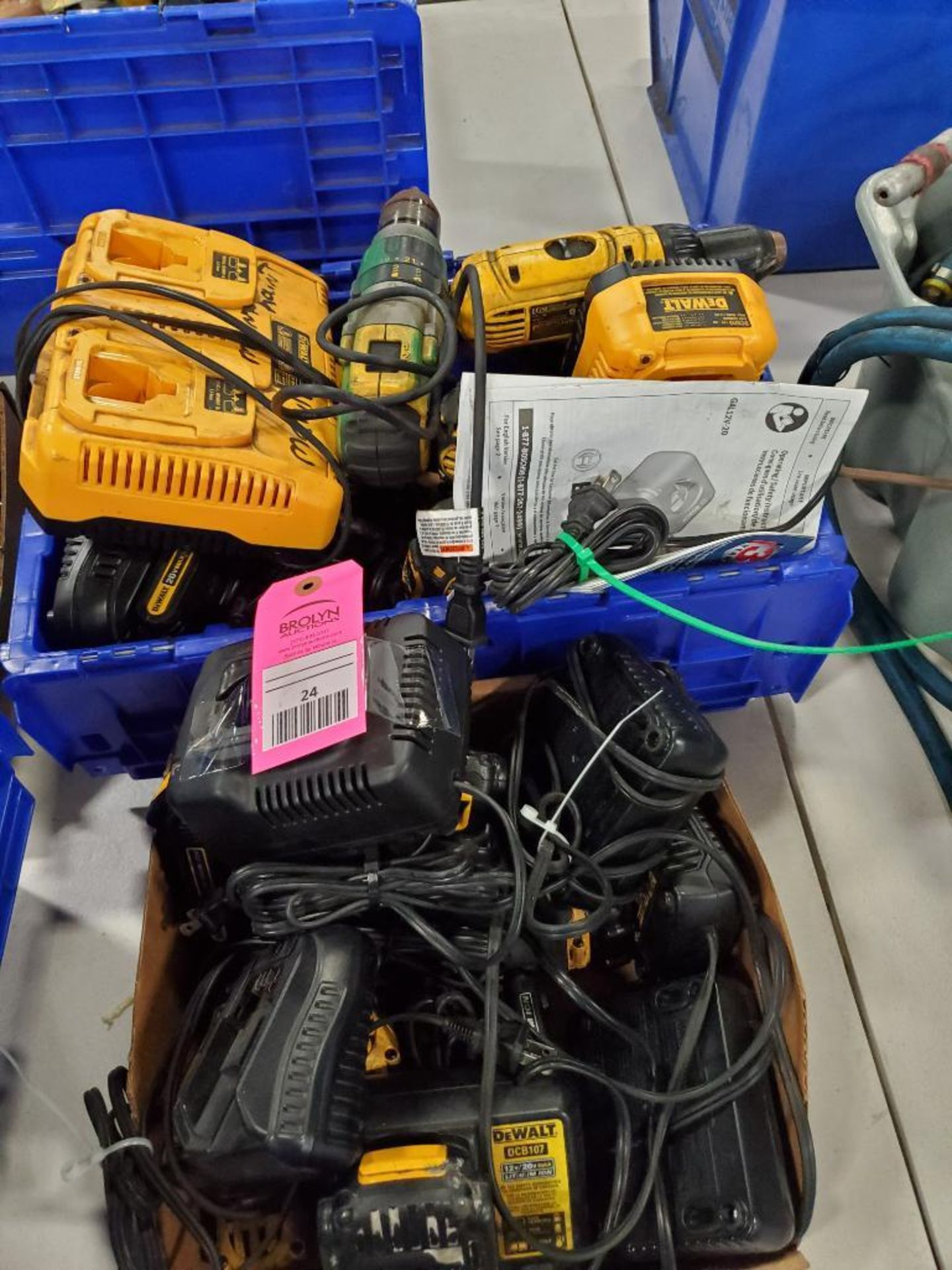 Assorted power tool batteries, chargers, and drills. DeWalt.