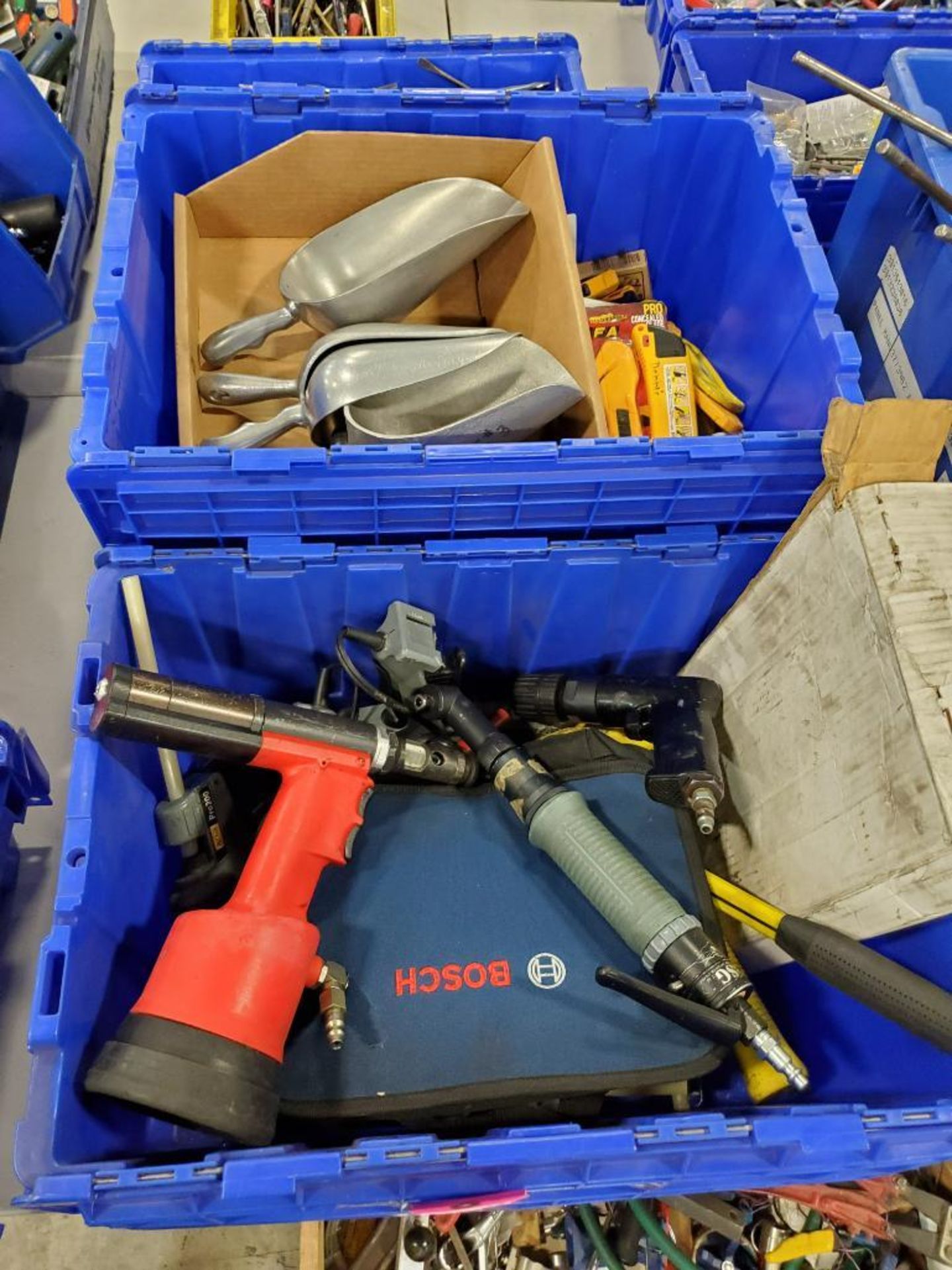 Assorted hand and air tools. glue guns, drills, scoops. knifes.