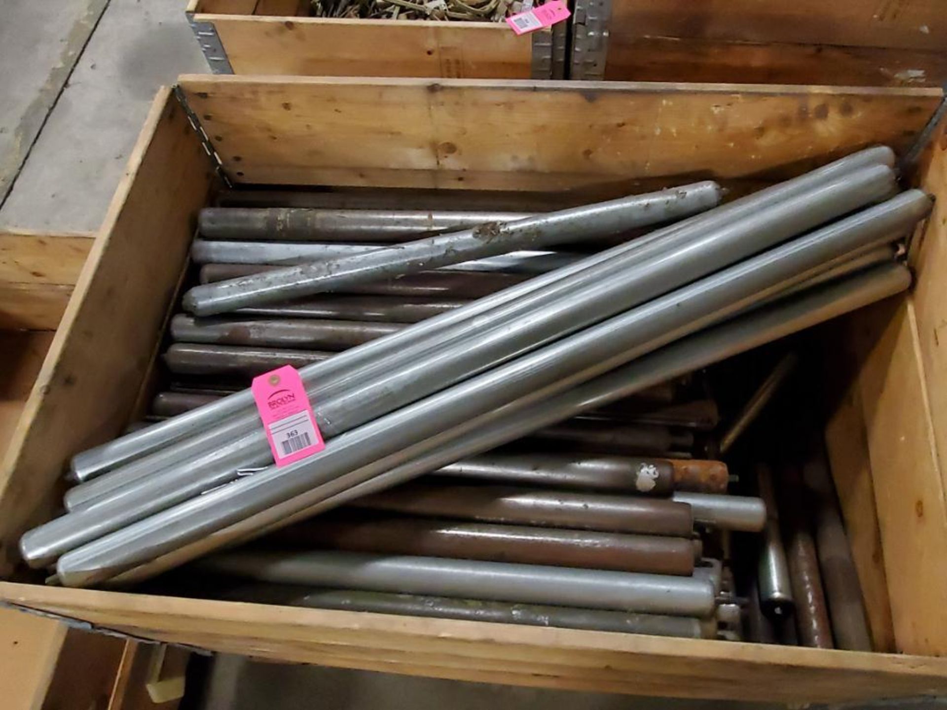 Crate of assorted roller table rollers.