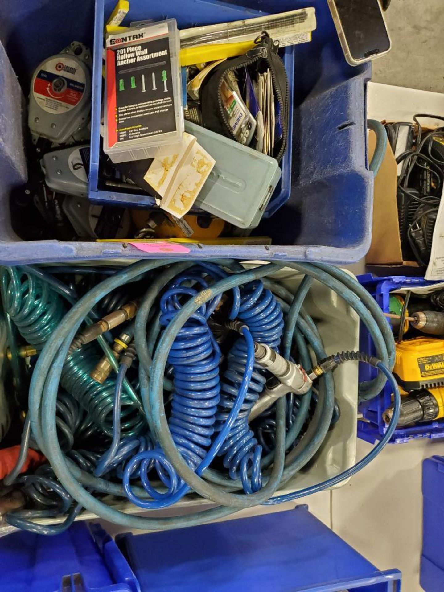 Assorted air tool accessories. Hose lines, tool balancers, and hardware.