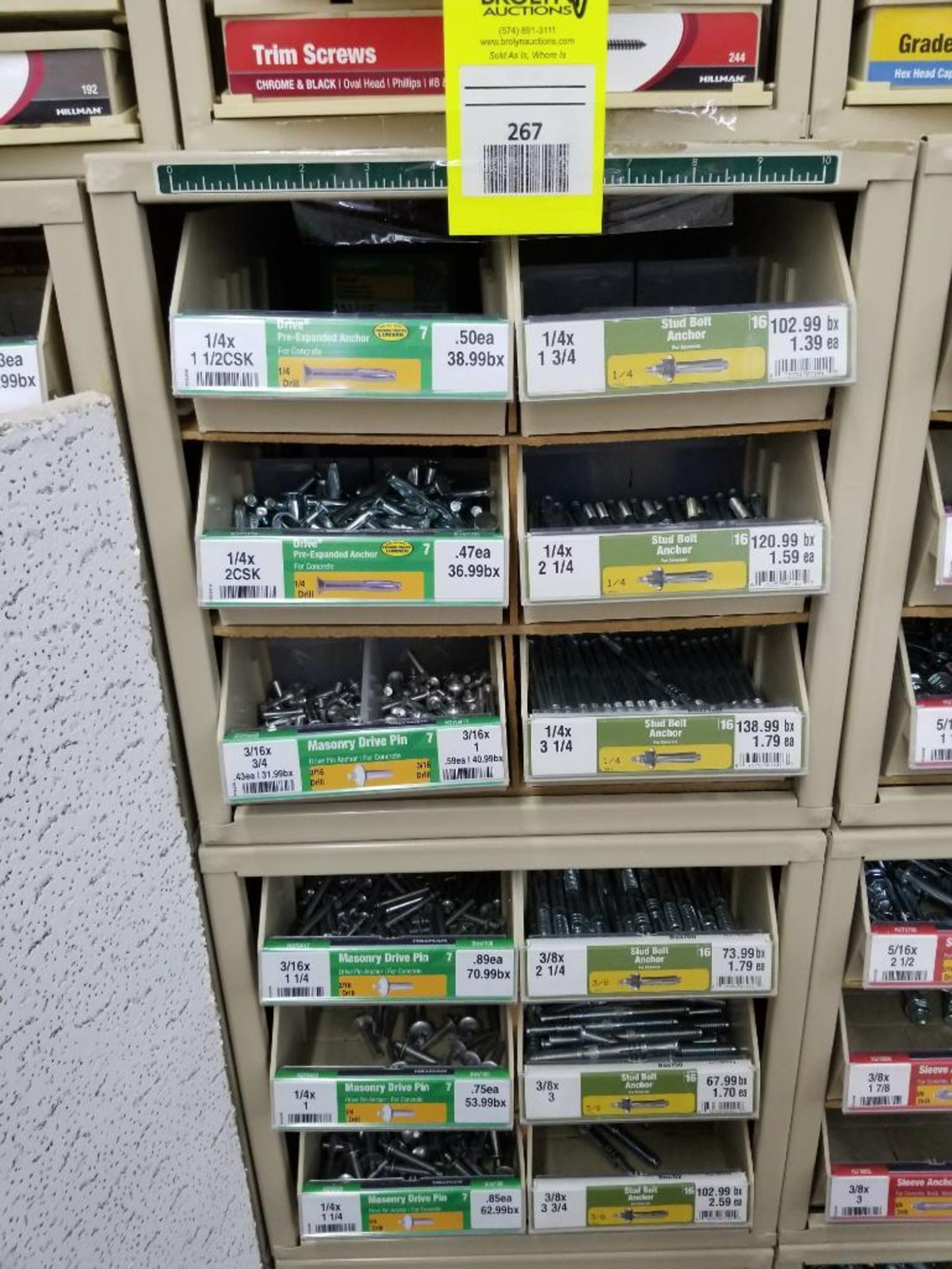 Full column section of bolt fastener display with bins, contents in bins and on top.