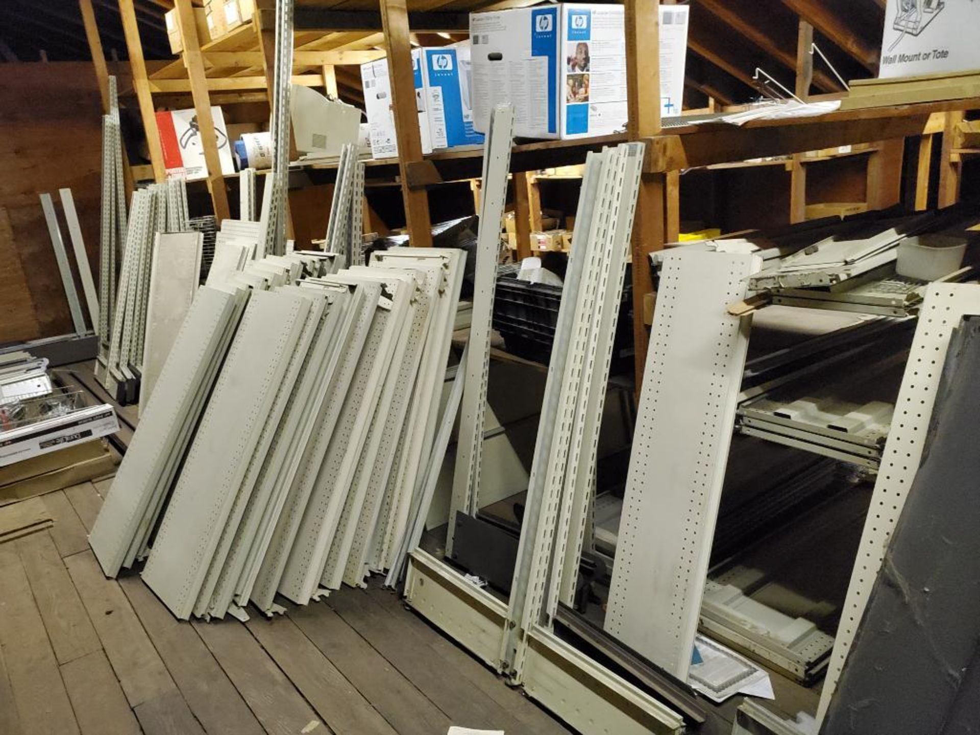 Large assortment of shelving components in attic.