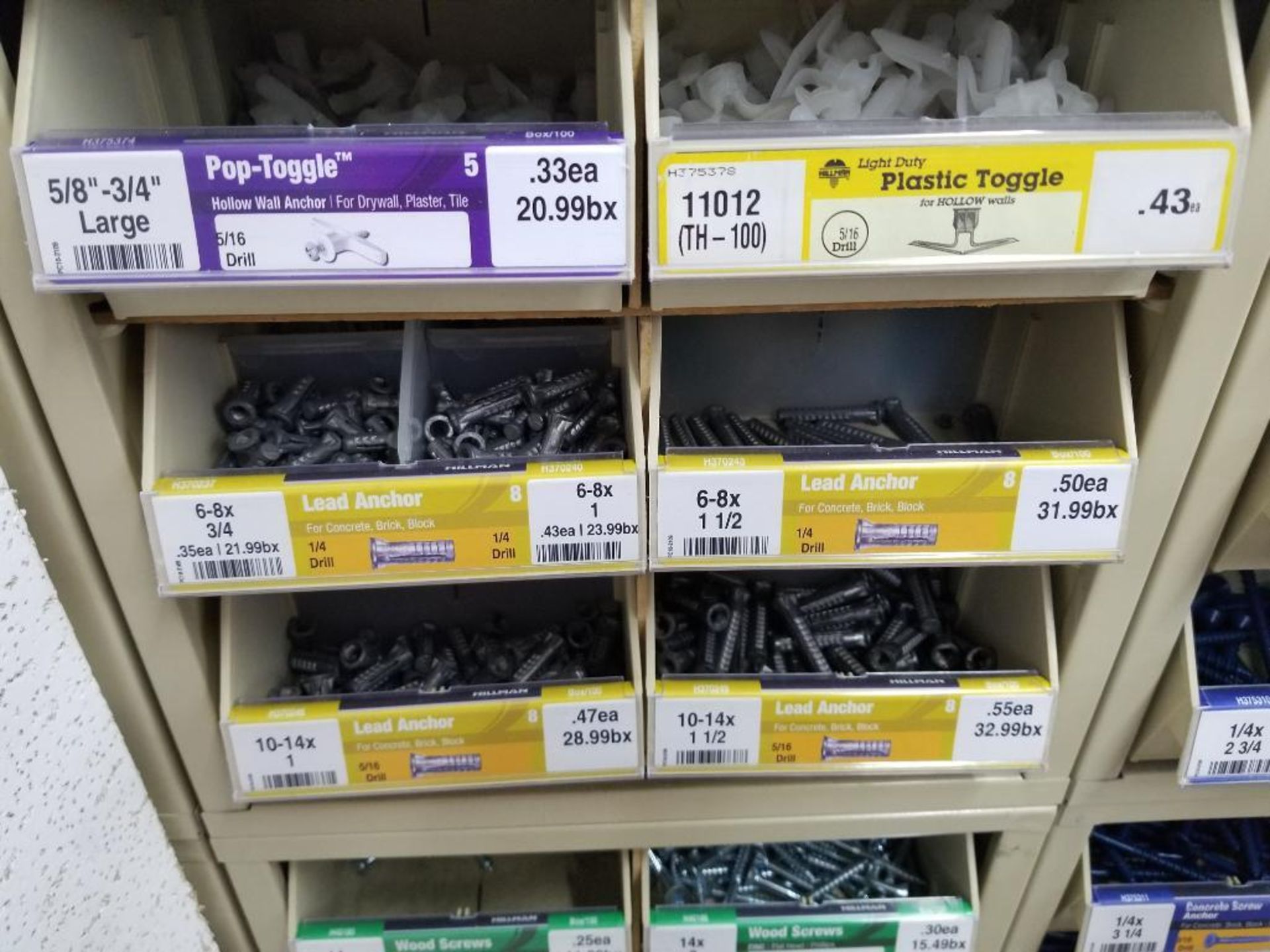 Full column section of bolt fastener display with bins, contents in bins and on top. - Image 11 of 12