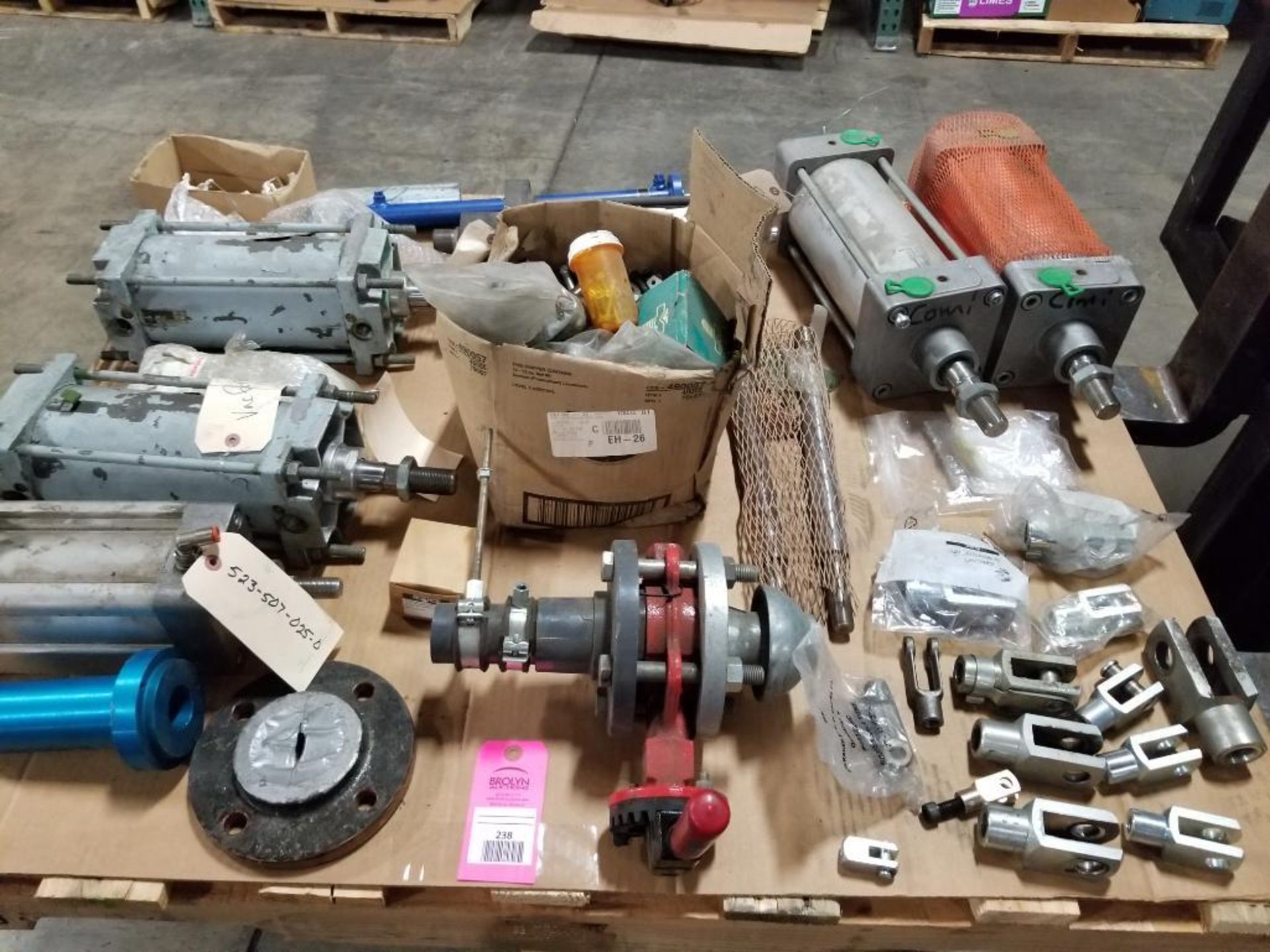 Pallet of assorted air cylinders, accessories, valves.