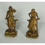 After Alfred Jean Foretay, a pair of gilt spelter figures of ladies leaning on a rustic fence,