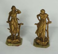 After Alfred Jean Foretay, a pair of gilt spelter figures of ladies leaning on a rustic fence,