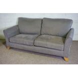 A pair of modern two seat sofas, both upholstered in light grey, on solid lightly tapered feet (