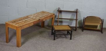 A modern slatted bench, small turned and caned stool, collapsable book shelves and a small swing