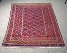 Kazakh Rug with geometric lozenges on a red ground, 173cm x 145cm