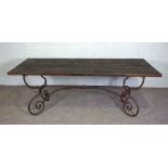 A large modern refectory style table, with a planked and aged rectangular top, set on a metal