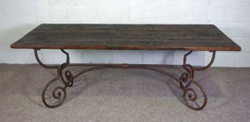 A large modern refectory style table, with a planked and aged rectangular top, set on a metal