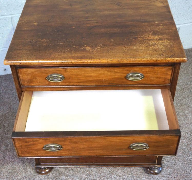 A small mahogany chest of drawers, 19th century, with four long drawers, on compressed bun feet, - Image 4 of 9