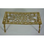A brass trivet, or iron stand, 19th century, with pierced rectangular top and turned brass legs,