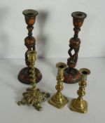 A pair of Kashmiri carved wood and painted lacquered candlesticks, with multi twist columns;