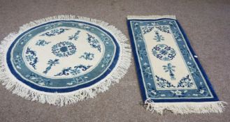 Two small modern floor rugs, one circular, 143cm diameter, one rectangular, 144cm long, 69cm wide,