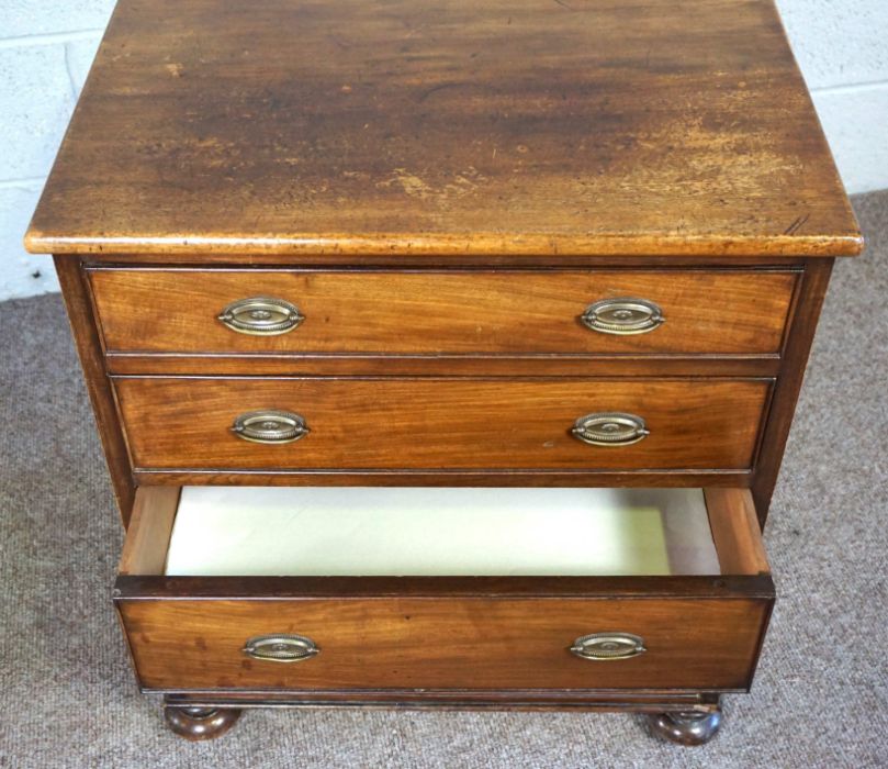 A small mahogany chest of drawers, 19th century, with four long drawers, on compressed bun feet, - Image 5 of 9