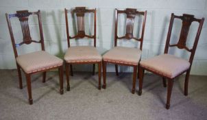 A set of four Edwardian salon chairs, with pierced slatted backs and stuffed over seats (4)