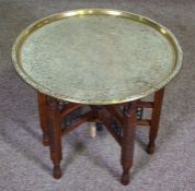 A Persian brass tray, on a folding stand, 60cm diameter