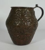 An interesting copper repousse decorated jug, Continental 18th/19th century, profusely decorated