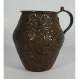 An interesting copper repousse decorated jug, Continental 18th/19th century, profusely decorated